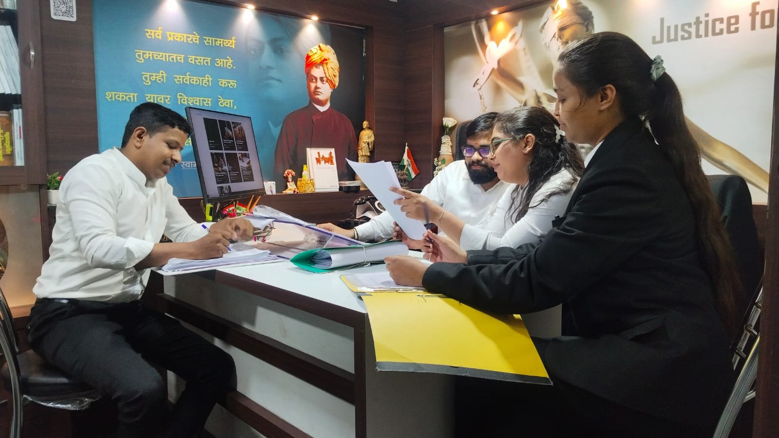 Indrajit Dongre & Associates legal team reviewing a case file at the Kasba Peth office